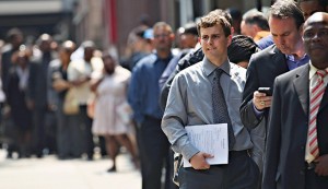 Applicants wait to enter a job fair in New York City. Some analysts question whether statistics used by the White House overestimate falls in unemployment