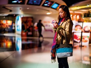 A woman stands outside a cinema complex in the US. More and more women are being represented in cinema, and female viewing figures are also increasing